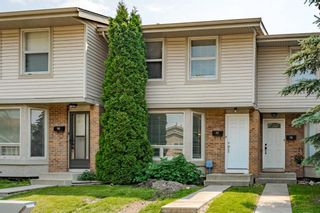 Photo 1: 77 123 Queensland Drive SE in Calgary: Queensland Row/Townhouse for sale : MLS®# A2040135